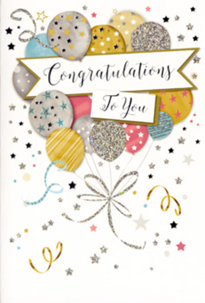 In this detailed product image, a tall rectangular congratulations card stands neatly against a neutral backdrop, its artwork capturing the buoyant feeling of a festive evening by the riverside in Blackwall. The focal point is an abundant bouquet of illustrated balloons clustered at the centre, with rounded shapes that seem to float upward in soft, overlapping layers. The colour palette is gentle yet luxurious: pale gold, muted silver, champagne, dusty rose, sky blue, and soft grey, all finished with a subtle metallic sheen that suggests shimmer even on a flat surface. Each balloon is decorated differently-some are sprinkled with starlike dots, others show fine vertical stripes or swirling patterns, and a few are touched with glittery accents-as if a designer has thoughtfully arranged visual textures the way a florist chooses complementary blooms. Emerging from the base of this cluster are slender, curling strings rendered in gold and silver, crossing and looping elegantly like trailing ribbons tied around a bouquet ready to be sent from a local Blackwall flower shop. A softly curved banner stretches across the middle of the balloons, carrying the message Congratulations To You in graceful script, the letters flowing in an easy rhythm that feels personal and heartfelt. Surrounding the central artwork, the background remains mostly light and uncluttered, but scattered across it are tiny stars, confetti dots, and swirling curls that give the impression of gentle movement and celebration, like confetti drifting to the floor after a toast in a nearby café. The entire card exudes joy, pride, and refined festivity, making it a thoughtful companion to flowers for graduations, career milestones, or any moment of achievement in and around Blackwall.