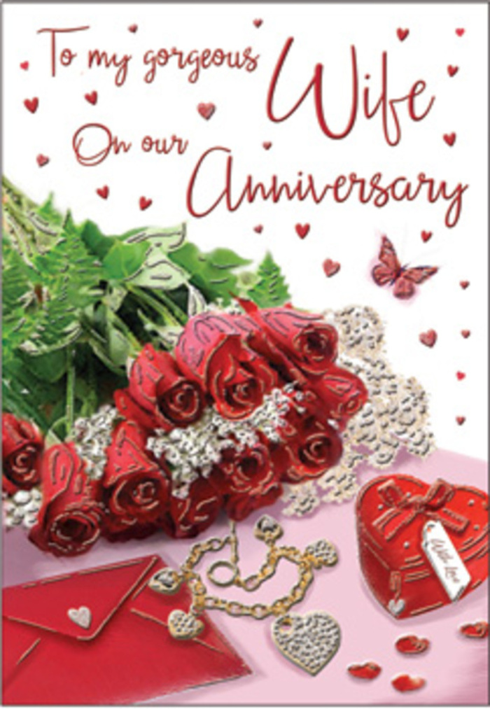 The image presents an emotive anniversary card scene, styled like a keepsake arrangement you might glimpse in a quiet Blackwall townhouse on a special evening. A bouquet of classic red roses takes the central focus; each bloom is luxuriously full, its petals unfurling in velvety layers that suggest both passion and reassurance. The roses are nestled in abundant greenery, the leaves glossy and fresh, bringing a sense of living, breathing nature into the composition, similar to the calm green corners found around nearby parks and riverside paths. Surrounding the flowers are delicate decorative touches: a heart-shaped box that hints at treasured mementos, a small set of jewellery with a romantic, intertwined design, and a richly coloured red box that suggests a lovingly wrapped gift exchanged across the years. Whisper-fine lace and dainty heart motifs accent the scene, catching the soft light in subtle highlights, like sun glancing off the water along the docklands. The scripted message on the card curves gracefully through the background, its elegant lettering blending into the overall design without overwhelming the roses. Gentle illumination bathes everything in a warm glow, enhancing the reds and golds and giving the card a sense of quiet luxury and intimacy. The arrangement feels thoughtfully curated, as though prepared by Blackwall Florist for a couple celebrating an anniversary steeped in shared stories, from first dates along the river to long, companionable walks home. Altogether, it's a romantic, tactile tableau that invites you to imagine the scent of fresh roses and the warmth of a heartfelt I love you.