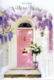 The scene shows a tender, welcoming doorway in Blackwall, styled as if a florist has written a love letter to new beginnings using flowers and paint instead of words. A pale pink front door, with a soft, matte finish, stands at the centre, radiating gentle warmth against the surrounding whitewashed wall. Overhead, generous cascades of wisteria pour down in fragrant lavender streams, their clustered blooms forming a loose, romantic canopy that frames the entrance like a natural garland. The vines twist and climb around the frame, casting dappled shadows across the door and suggesting the filtered light of a mild afternoon by the Thames. One side of the façade carries a subtly painted shutter in a matching blush tone, repeating the pink notes and adding a pleasing balance to the composition. At the threshold, a chic grey metal bucket holds a lavish arrangement of white and cream roses, their petals velvety and layered, nestled among soft green foliage that peeks out in gentle ripples. A dusty-rose ribbon is tied around the base, its satin texture catching the light and tying the floral palette back to the pink door. The entire setting feels calm and hopeful, like that first quiet pause after moving into a new apartment near Blackwall Way or the bridges towards Canary Wharf, when the bustle fades and the promise of home begins. The combination of cool stone steps, pastel paint, and fresh flowers creates a harmonious, almost cinematic moment-an understated celebration of a new address, filled with the unspoken wish that whoever steps through this door will be met with comfort, joy, and the steady rhythm of everyday life settling beautifully into place.